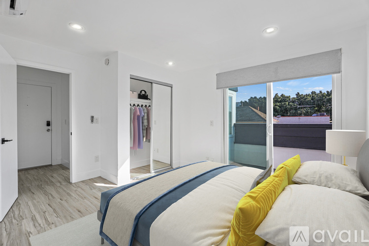 A bedroom with a large bed and a view of a lake.