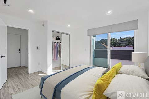 A bedroom with a large bed and a view of a lake.