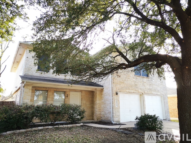 A house with a tree in front of it.
