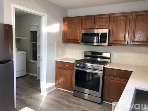 A kitchen with a stove top oven and microwave above it.