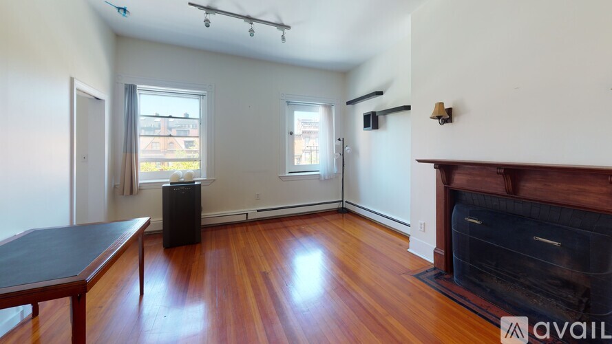 A room with a fireplace and a wooden floor.