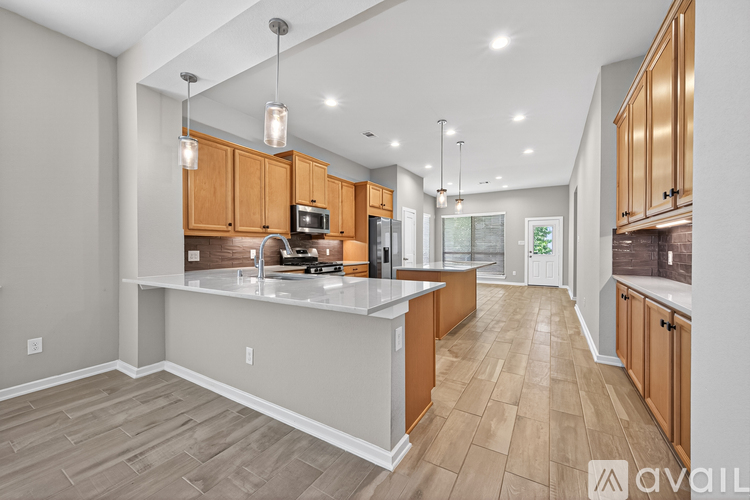 A modern kitchen with wooden cabinets and a central island.