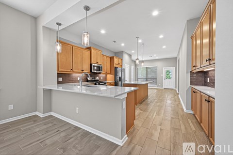 A modern kitchen with wooden cabinets and a central island.