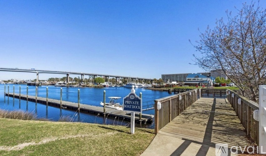 A wooden walkway leads to a dock with a sign that reads "PRIVATE BAY BARRAGE".