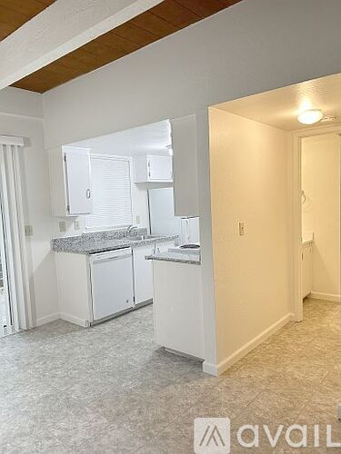 A kitchen with white cabinets and a countertop.