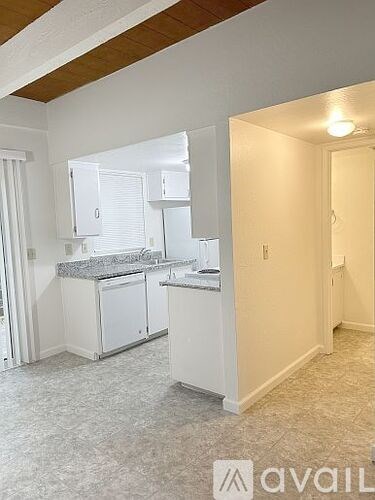 A kitchen with white cabinets and a countertop.