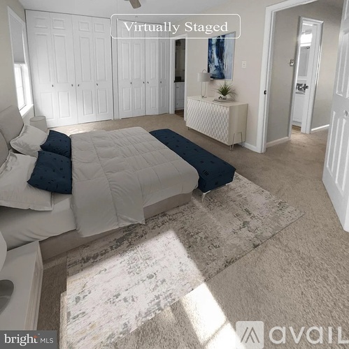 A bedroom with a bed, dresser, and a window.