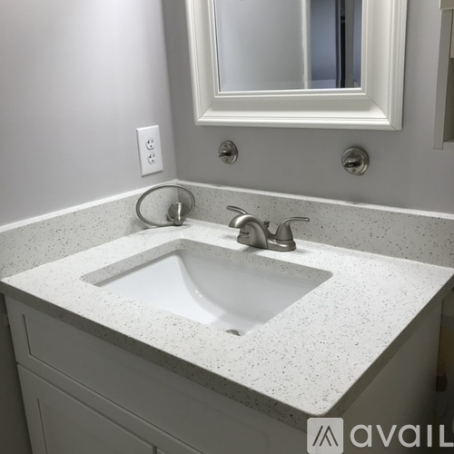 A bathroom sink with a mirror above it.
