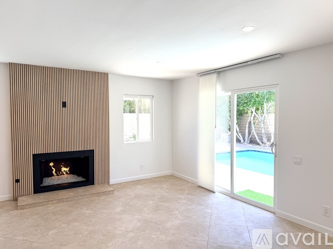 A living room with a fireplace and sliding glass doors.