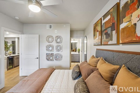 A living room with a couch and a painting on the wall.