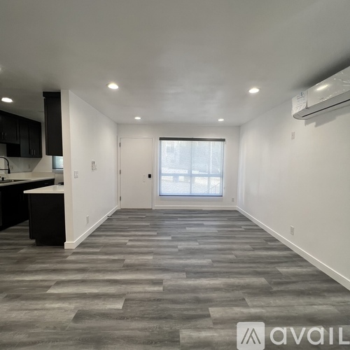 A spacious room with a grey floor and a white ceiling.