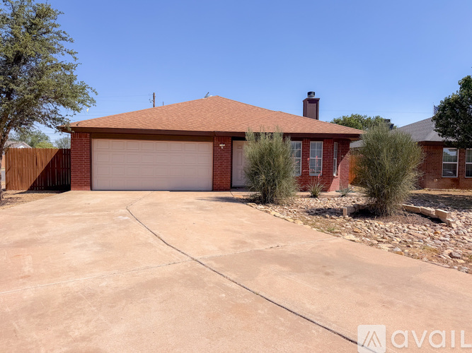 A house with a red roof and a garage door.
