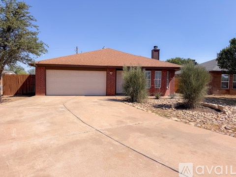 A house with a red roof and a garage door.