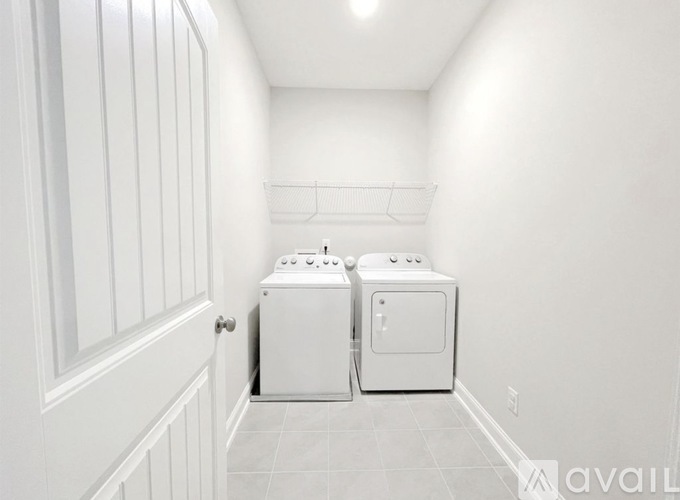 A small white laundry room with a washer and dryer.