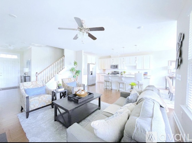 A living room with a grey couch and a black coffee table.