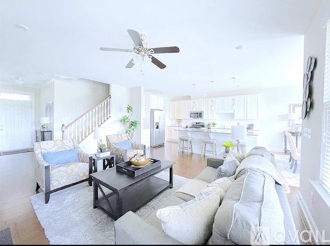 A living room with a grey couch and a black coffee table.