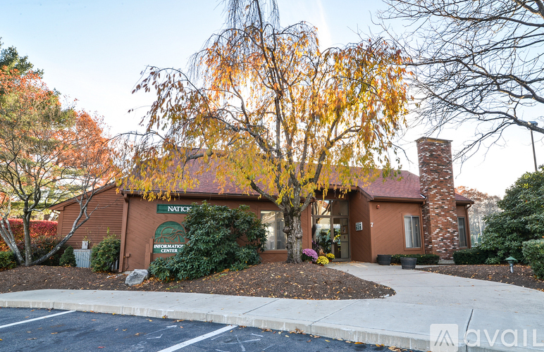 A brick building with a tree in front of it.