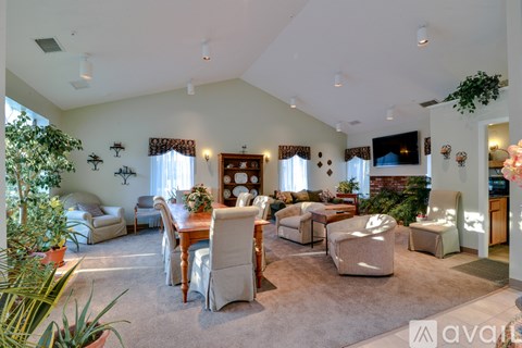 A living room with a dining table and chairs.