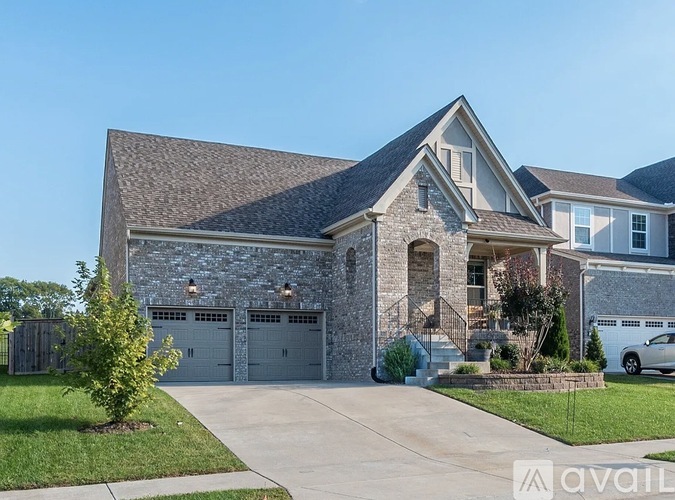 A house with a stone facade and a garage door.