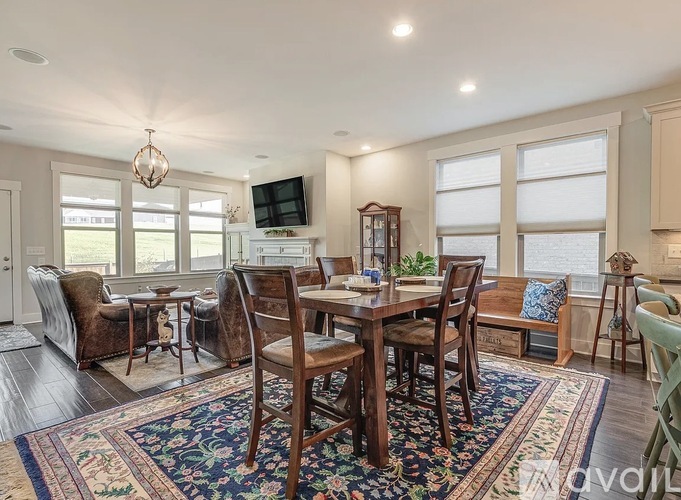 A dining room with a wooden table and chairs.