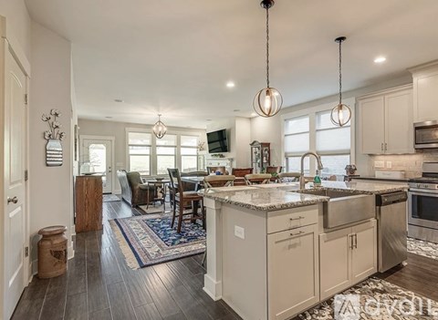 A kitchen with a dining table and chairs.