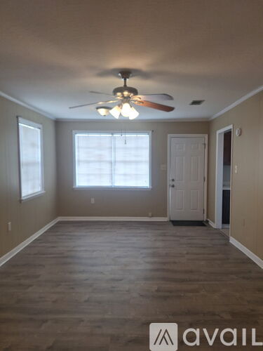 A room with a fan and a door.