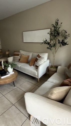 A living room with a white couch and a coffee table.