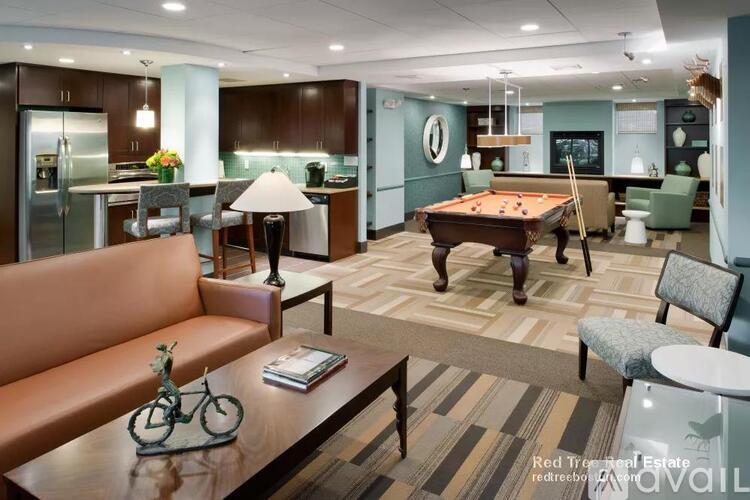 A living room with a pool table and a couch.