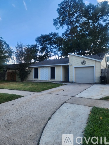 A two-story house with a garage and a driveway.
