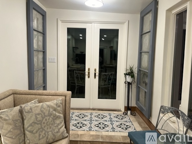 A living room with a sofa, a table, and a glass door.