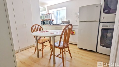 A small table with two chairs in a kitchen.