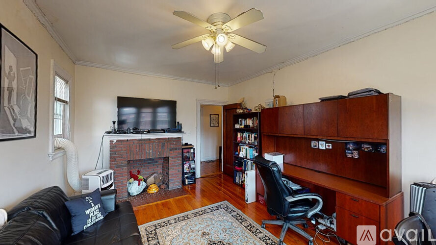 A living room with a fireplace and a bookshelf.