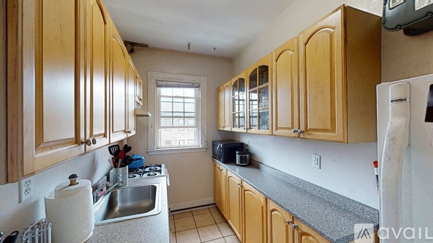 A kitchen with wooden cabinets and a white refrigerator.