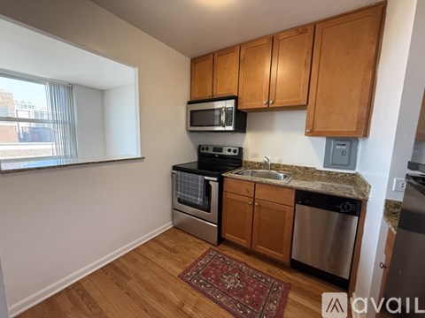 A kitchen with wooden cabinets and stainless steel appliances.