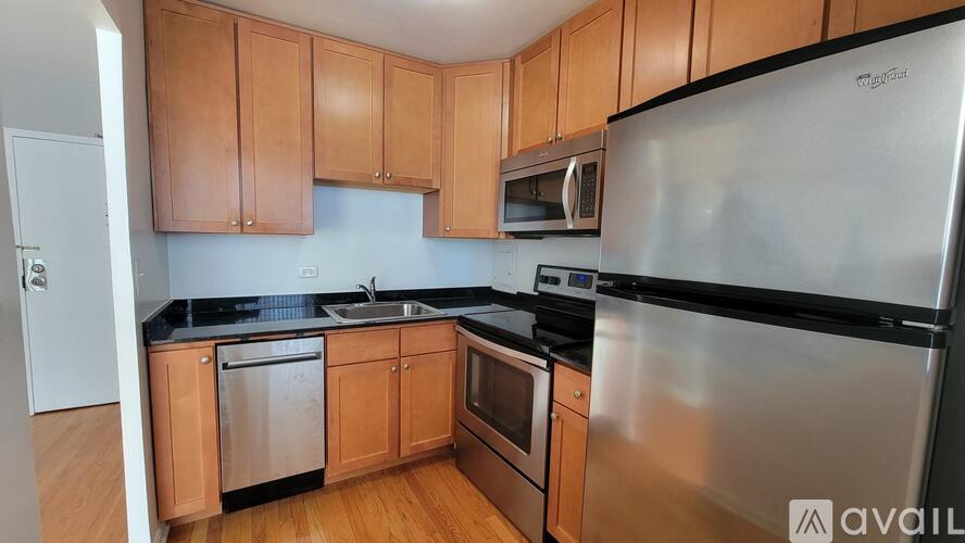 A kitchen with wooden cabinets and stainless steel appliances.