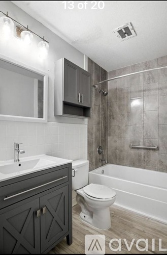 A bathroom with a white toilet and a bathtub.