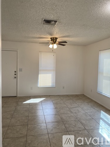 A room with a tiled floor and a ceiling fan.