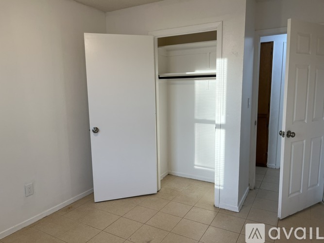 A white door is open to a hallway.
