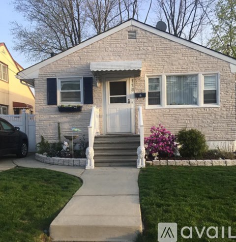 A house with a white door and a small front yard.