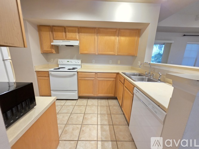 A kitchen with wooden cabinets and white appliances.
