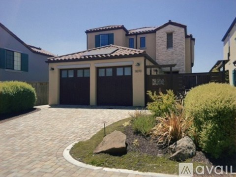 A house with a driveway and garage doors.