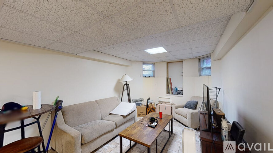 A living room with a couch, chair, and television.