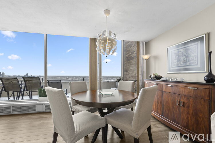 A dining room with a table and chairs and a chandelier.