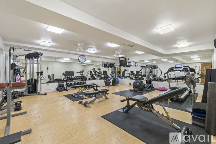 A well-equipped gym with various exercise machines and weights.