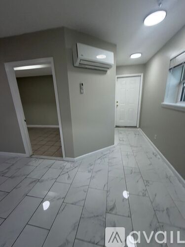 A room with a marble floor and a window.