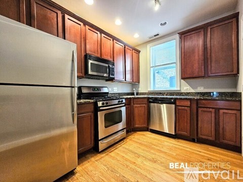 A kitchen with wooden cabinets and stainless steel appliances.
