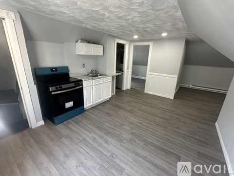 A kitchen with a black oven and white cabinets.
