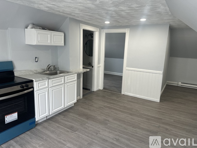 A kitchen with a blue oven and white cabinets.
