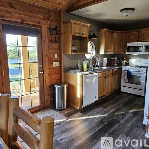A kitchen with wooden cabinets and a white fridge.