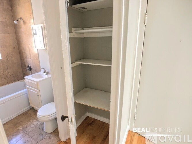 A small, empty bedroom with a toilet and a sink.